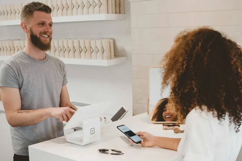 The Technical Race Behind Central Asia’s Homegrown Payment Apps A customer paying with a smartphone at a modern shop counter.