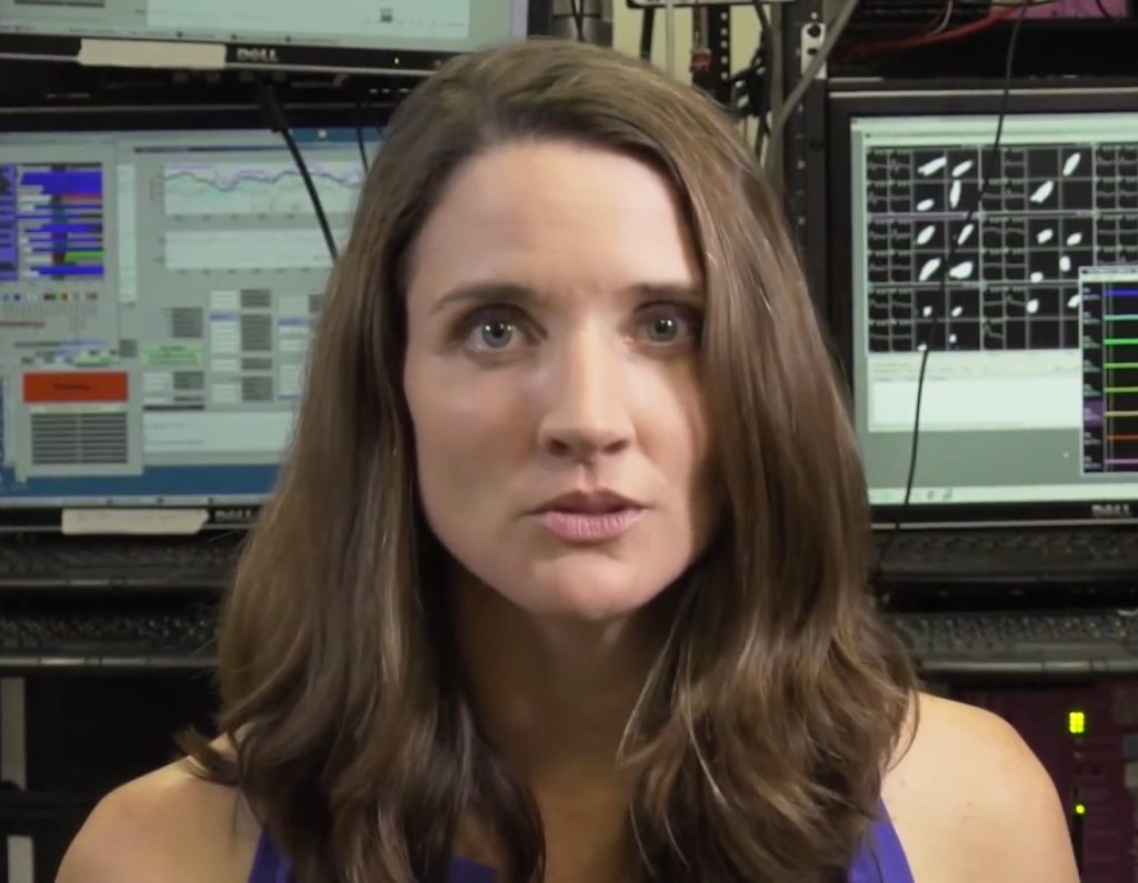 Brain–Computer Interface Trials Widen Beyond the First Patients A researcher examining brain activity signals on a laboratory monitor