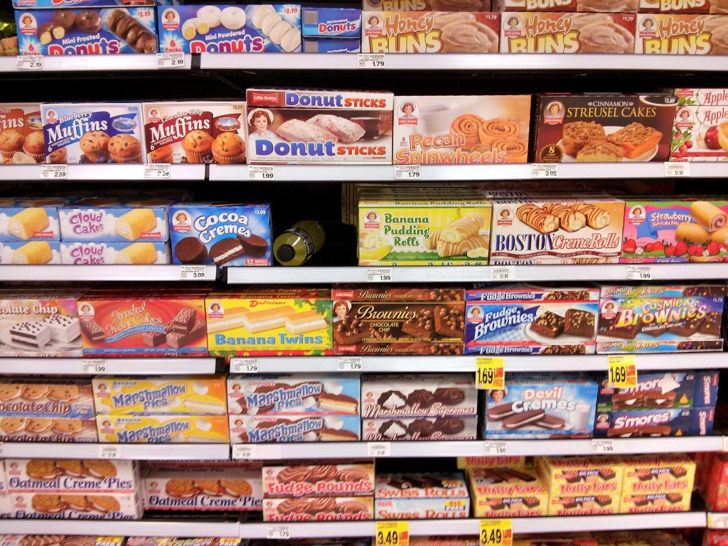 Ultra-Processed Foods: Study Finds Industry Links in Definition Debate Supermarket shelves with packaged foods under a food labelling study discussion